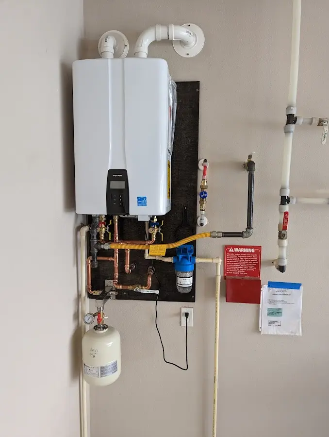 Professional plumber installing copper piping in a Warrensville Heights home